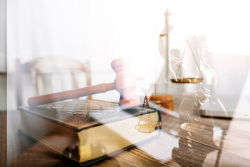 Justice and law concept.Male judge in a courtroom with the gavel, working with, computer and docking keyboard, eyeglasses, on table in morning light