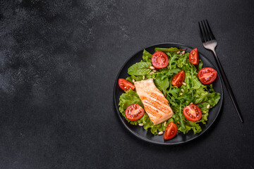 Delicious fresh salad with fish, tomatoes and lettuce leaves