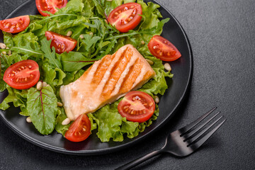 Delicious fresh salad with fish, tomatoes and lettuce leaves