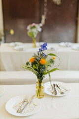 Beautiful floral arrangement and table setting at a wedding