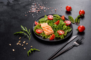 Delicious fresh salad with fish, tomatoes and lettuce leaves