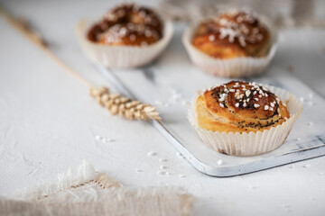 Fresh cinnamon buns on wooden cutting board