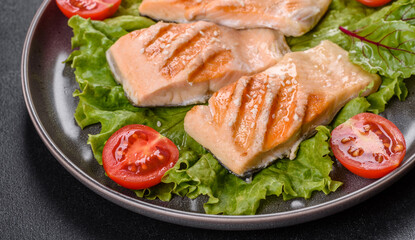 Delicious fresh salad with fish, tomatoes and lettuce leaves