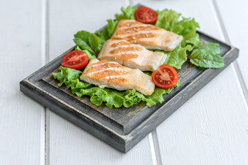 Delicious fresh salad with fish, tomatoes and lettuce leaves