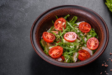 Pieces of chicken, tomatoes and lettuce leaves on a dark concrete background