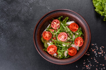 Pieces of chicken, tomatoes and lettuce leaves on a dark concrete background