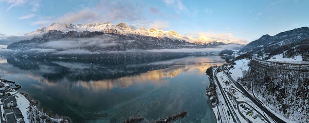 180 Panorama of mountain chain reflected in lake during sunset located in switzerland