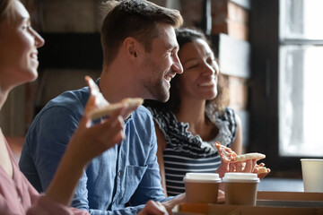 Happy young caucasian man enjoying spending carefree leisure weekend time in cafe with mixed race diverse mates, having fun joking communicating, entertaining together, friendship relations concept.