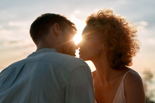 Portrait of young caucasian lovers tenderly kissing