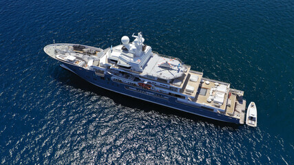 Aerial drone photo of luxury yacht anchored in Mediterranean destination island with deep blue sea