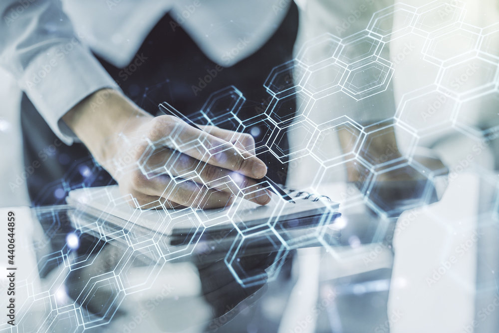 Poster double exposure of technology hologram with hexagon and man hand writing in notebook on background. 