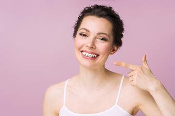Orthodontic Treatment. Dental Care Concept. Beautiful Woman Healthy Smile close up. Closeup Ceramic...