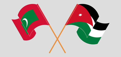 Crossed and waving flags of Maldives and Jordan