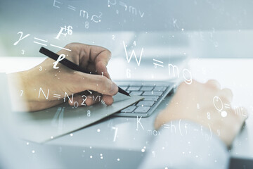 Creative scientific formula illustration with hand writing in diary on background with laptop, science and research concept. Multiexposure