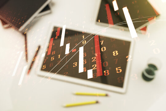 Abstract creative financial graph and modern digital tablet on desktop on background, top view, financial and trading concept. Multiexposure