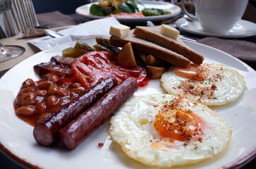 English breakfast. Scrambled eggs with sausages and toast. High quality photo
