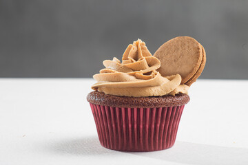 Chocolate cupcake with hazelnut cream decorated with a cookie