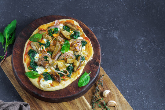 Traditional italian pizza with spinach, mushrooms, mozzarella, onion. Top view with copy space