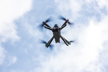 Flying drone photographed from below