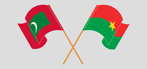 Crossed and waving flags of Maldives and Burkina Faso