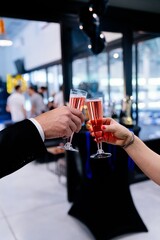 Toasts with champagne glasses at a corporate event or business meeting.