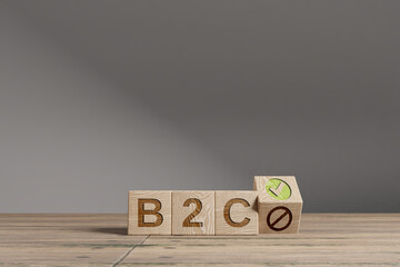 Wood cubes with acronym 'B2C' - 'Business To Customer' on a beautiful wooden table, studio background. Business concept and copy space.