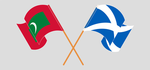 Crossed and waving flags of Maldives and Scotland