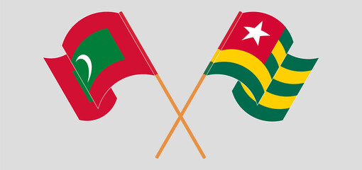 Crossed and waving flags of Maldives and Togo