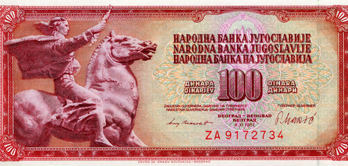 paper money banknote bill of Yugoslavia 100 dinara. Shows man riding horse horseman sculpture monument