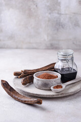 Carob pods, powder and molasses or syrup