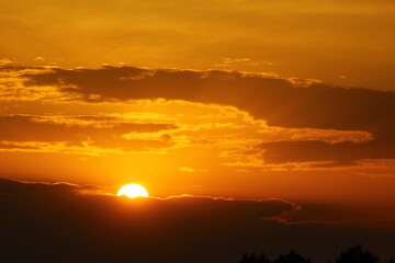 Fototapeta na wymiar Beautiful sunset with dark clouds and orange sky