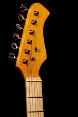 Electric guitar neck with six strings on a black background. Close-up.
