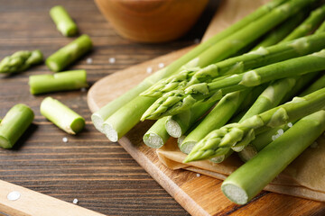 Fresh asparagus on wooden background, close-up.