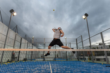 Young man with urban style trains playing duel on an outdoor court