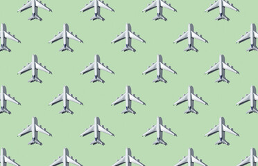 Pattern of plane models on green pastel background