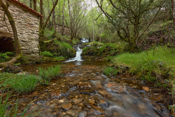 Beautiful waterfalls formed by a river in the area of Galicia, Spain.