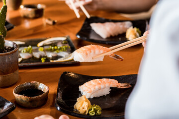 Delicious Sushi Menu Food Sashimi Salmon Tuna Shrimp Hashi Holds Gourmet Plate Restaurant Wooden Table