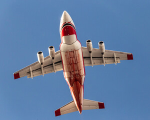 Avro RJ-85 flying back to base after dropping retardant on the Left Hand Canyon forest fire. Fire retardant is seen along the plane's belly and fuselage.