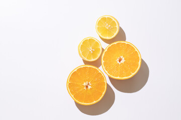 Halves of orange, lemon on white background. Top view. Composition of juicy citruses with place for text. Concept of diet, health, taste, food. Isolated. Bright light. 9x16. Copy space