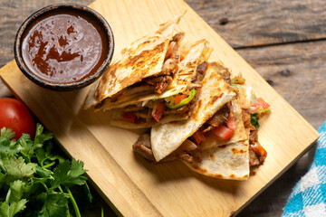 Grill steak mulitas with fresh sauce and cheese on wooden background. Mexican food