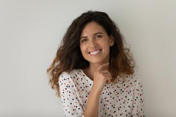 Head shot portrait of smiling beautiful woman standing isolated on grey studio background, happy...
