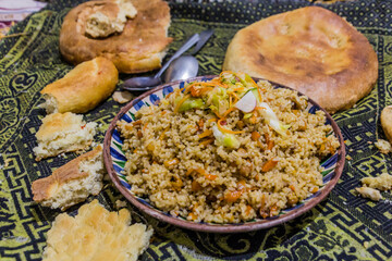 Plov and bread, traditional meal in Tajikistan