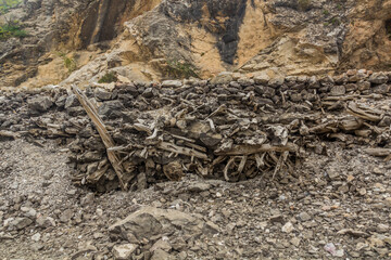 Fototapeta na wymiar Stone wall of a path in Marguzor (Haft Kul) in Fann mountains, Tajikistan