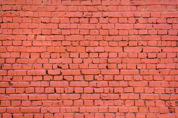 The brick wall is painted red. Focusing in the center of the frame.
