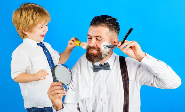 Assistant for dad. Son and father shaving beard together. Barbershop. Beard care. Little barber.
