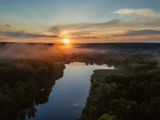 Sunset above the river in natural rural landscape