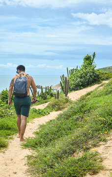 man walking along the coast