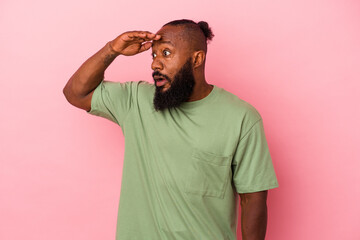 looking far away keeping hand on forehead.