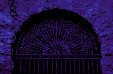 Purple and black purple halloween background. A dark cavern with and ornate decorative iron gate