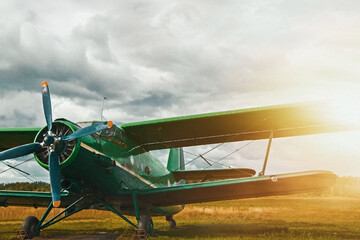 Vintage aircraft preparing for take-off on the background of stormy sky